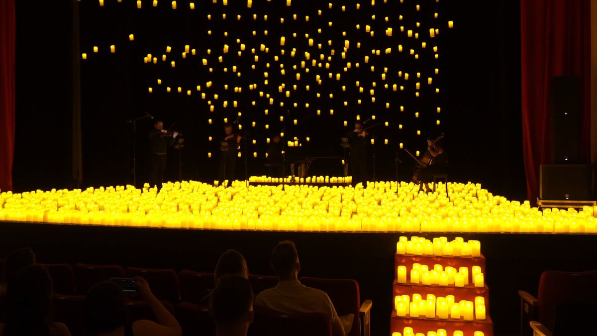 Plateia diante da cortina de velas suspensas